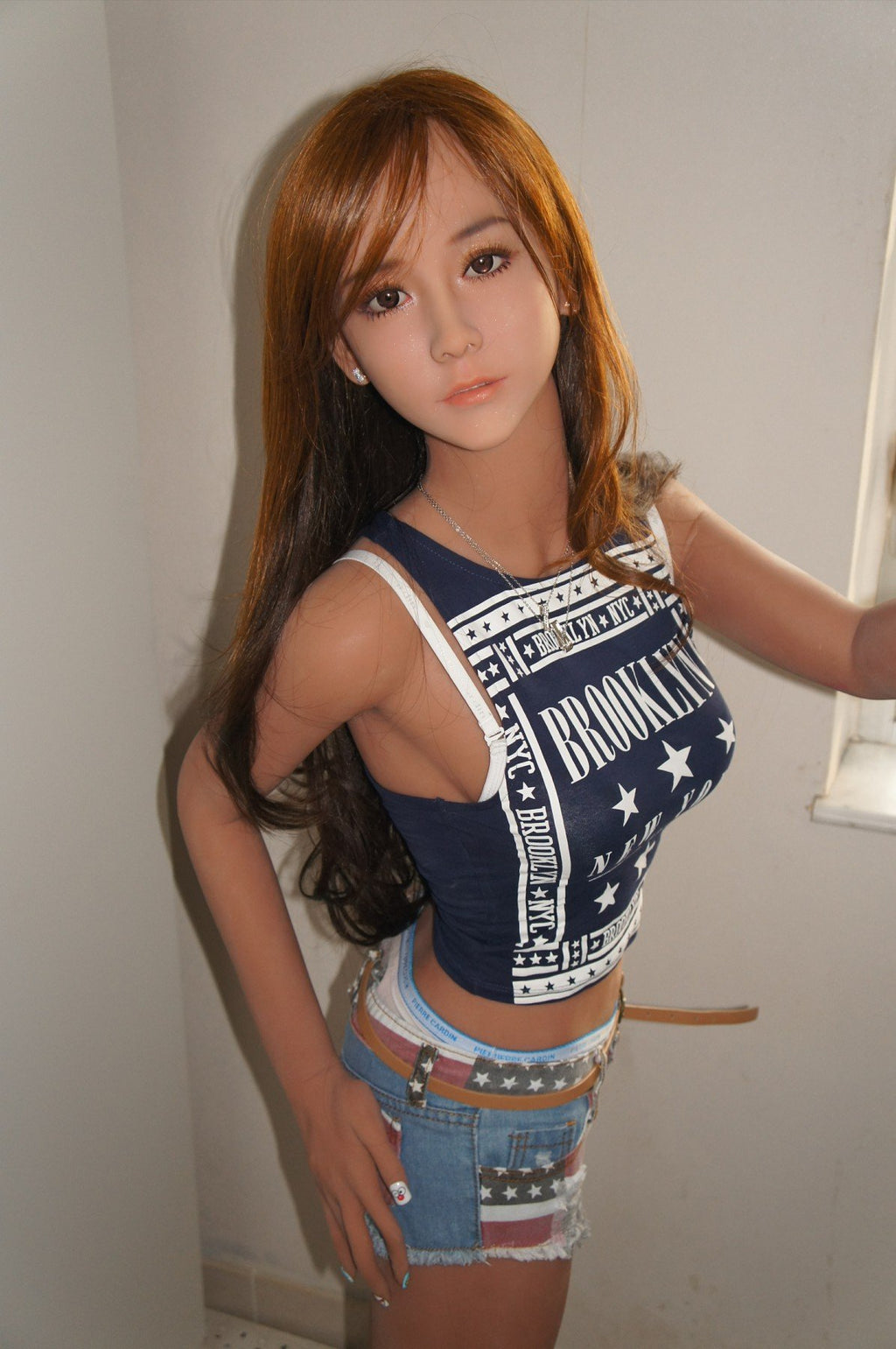 A doll with a slim body, perky hips, and plump breasts and buttocks, as well as a face-thinning realistic doll