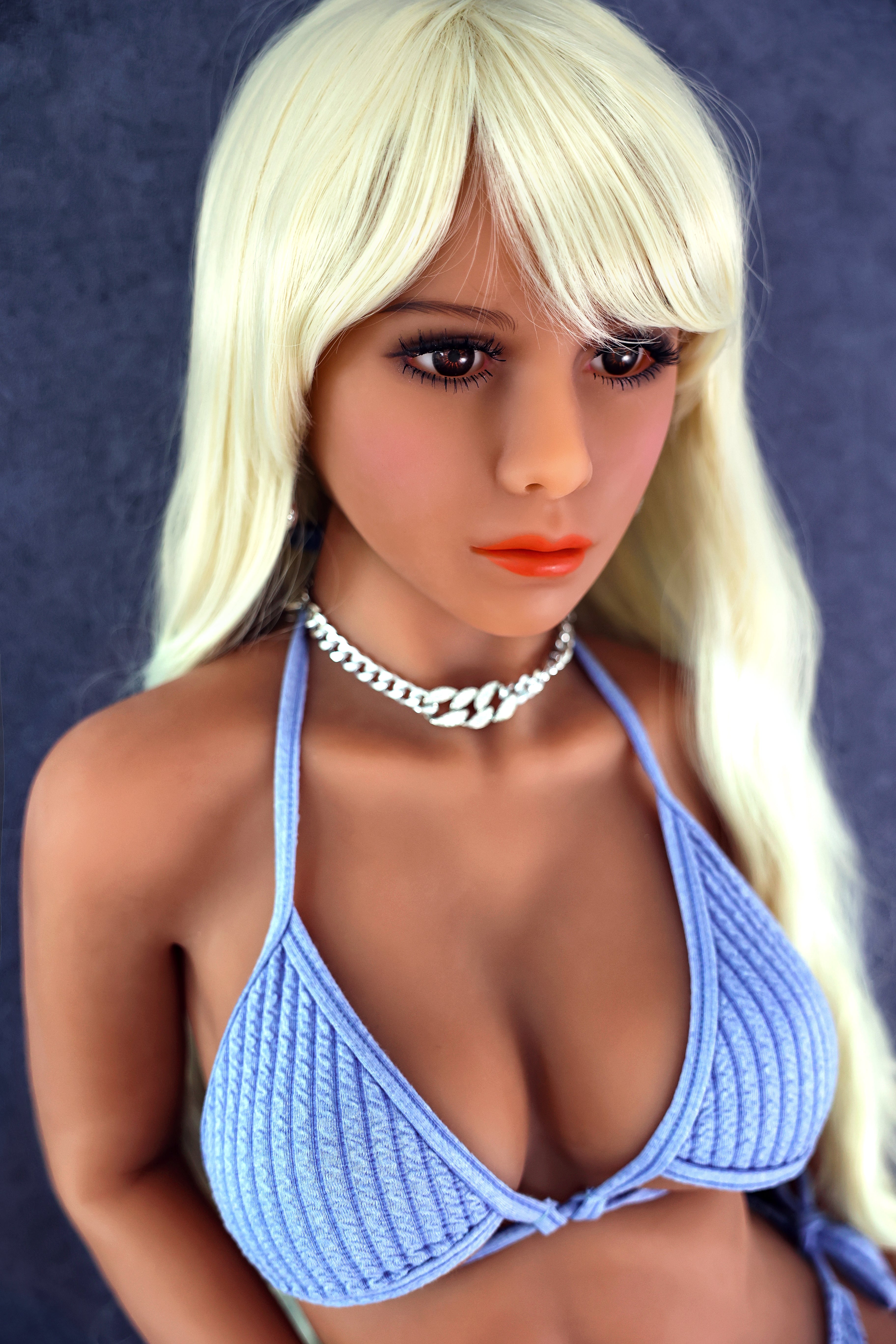 Cute and sexy doll with big breasts and buttocks, resembling a real person
