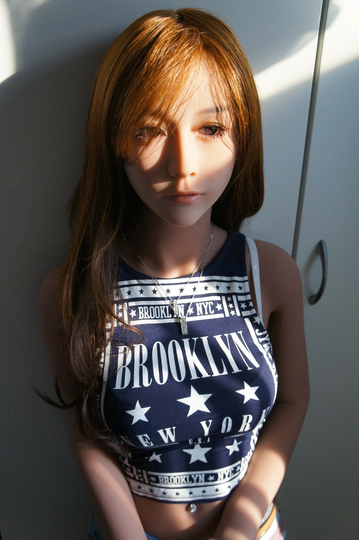 A doll with a slim body, perky hips, and plump breasts and buttocks, as well as a face-thinning realistic doll
