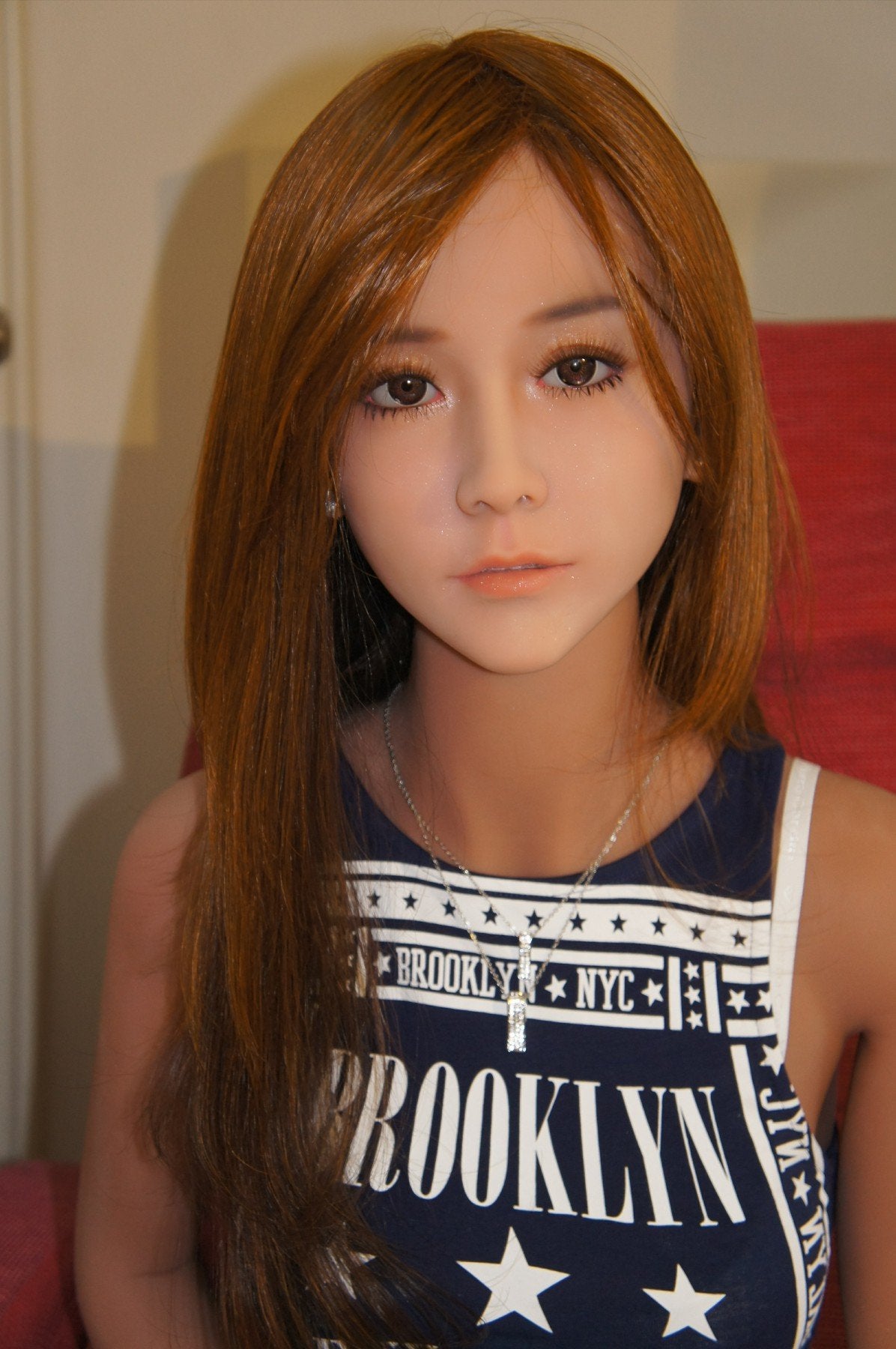 A doll with a slim body, perky hips, and plump breasts and buttocks, as well as a face-thinning realistic doll